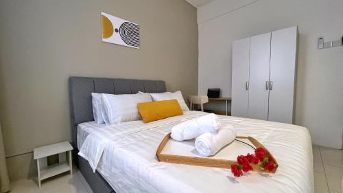 a bedroom with a bed with towels and flowers on it at BM IconCity Landed Home by Wemestay - Near AutoCity, Juru, Penang Bridge in Bukit Mertajam
