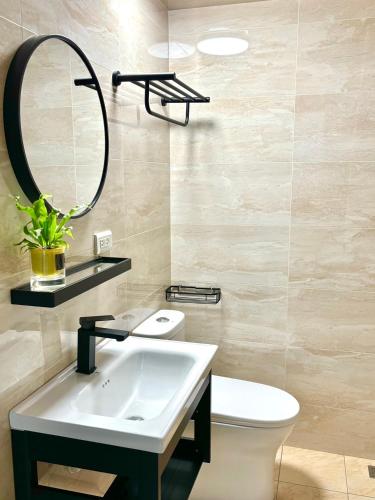 a bathroom with a sink and a mirror and a toilet at 隱 the house in Magong
