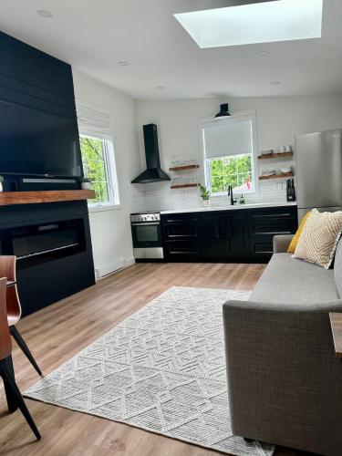 a living room with a couch and a kitchen at Garden Suite with Pool and Sauna in Brampton