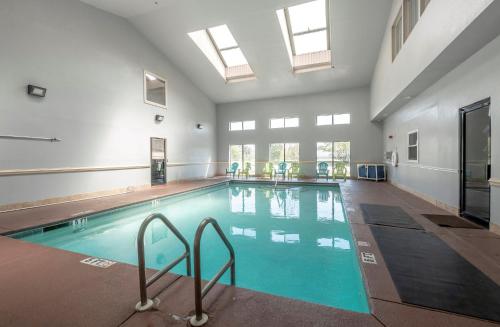 a large swimming pool with blue water in a building at Red Roof Inn & Suites Pensacola-NAS Corry in Pensacola