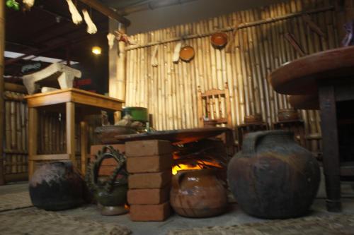 a room with a fireplace and a table and a fire at Hotel El Tambor OASIS Antigua Guatemala in Antigua Guatemala