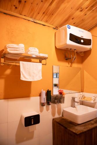 a bathroom with a sink and a machine on the wall at Junsu house in Sapa