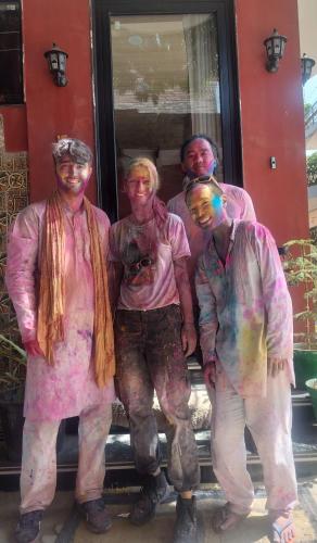 a group of people covered in paint posing for a picture at Kishan Home Stay in Mathura