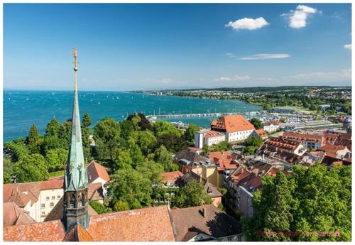 a view of a town with a steeple of a church at Konstanzer Ferienwohnungen in Konstanz