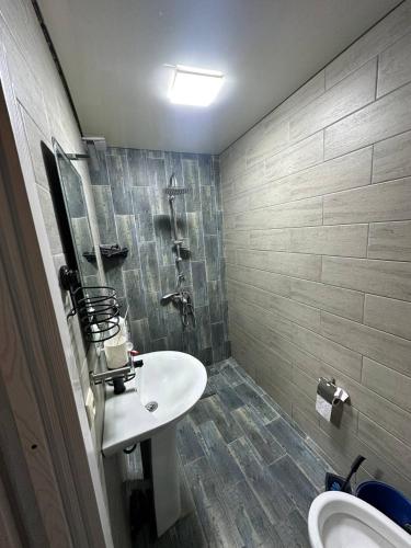 a bathroom with a sink and a shower at BlackSeaAp in Kobuleti