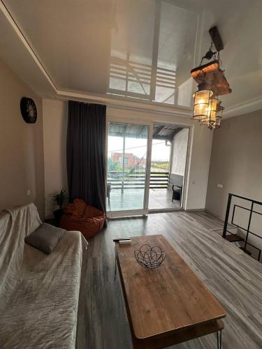 a living room with a couch and a coffee table at BlackSeaAp in Kobuleti