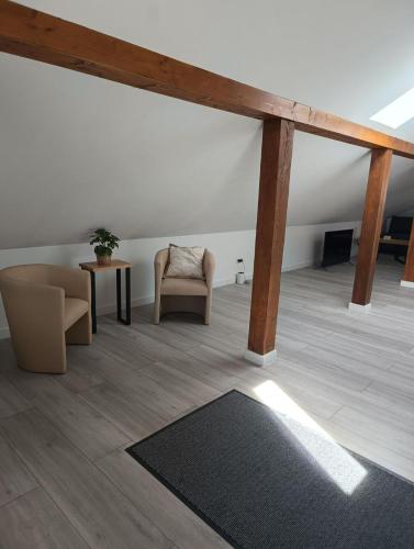a living room with a couch and a chair and a table at Włostowicka Ostoja Apartament in Puławy
