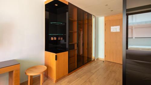 a walk in wardrobe with a stool in a room at voco Dubai Monaco, the Heart of Europe by IHG in Dubai