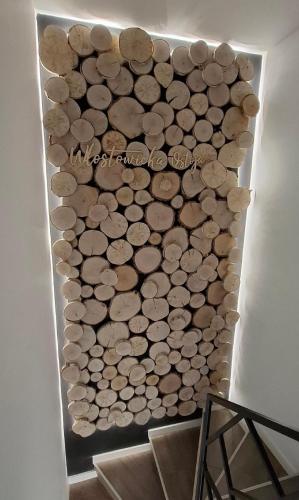 a wall of wood logs in a room at Włostowicka Ostoja Apartament in Puławy