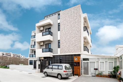 a building with a car parked in front of it at Penghu Storyteller in Magong