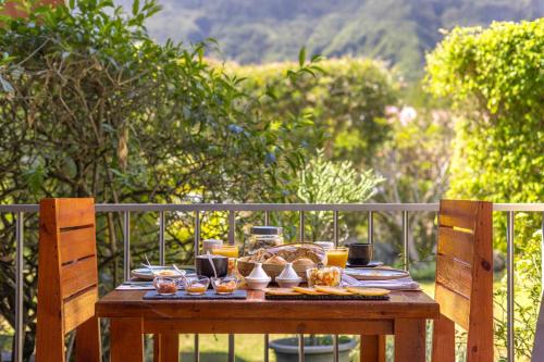 a wooden table with food on top of it at La Villa Soalic in Cilaos