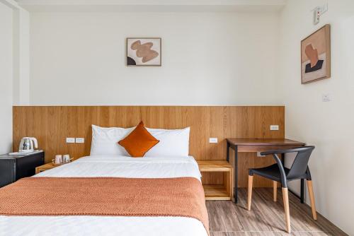 a hotel room with a bed and a desk at Penghu Storyteller in Magong