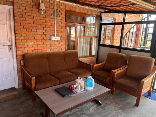 a living room with two chairs and a coffee table at Saanvi Hotel & Restaurant in Kathmandu