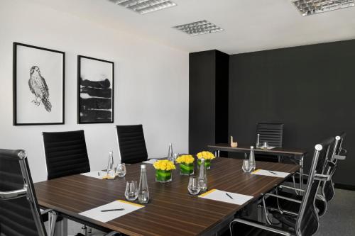 a conference room with a wooden table and chairs at voco Dubai by IHG in Dubai