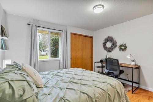 a bedroom with a bed and a desk and a chair at Large Family-Friendly Home on NW Side - Dogs OK in Olympia
