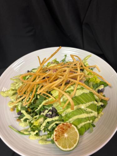 a white plate with a salad with lettuce and carrots at Holiday Inn Montreal Longueuil by IHG in Longueuil