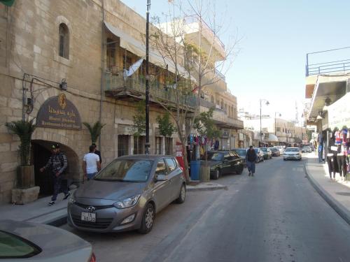a small car parked on the side of a street at Madaba Hotel in Madaba
