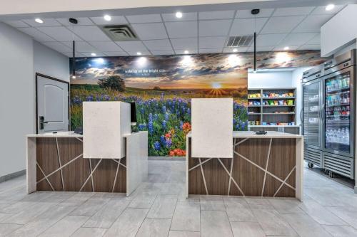 an office with a flower mural on the wall at La Quinta by Wyndham Allen at The Village in Allen