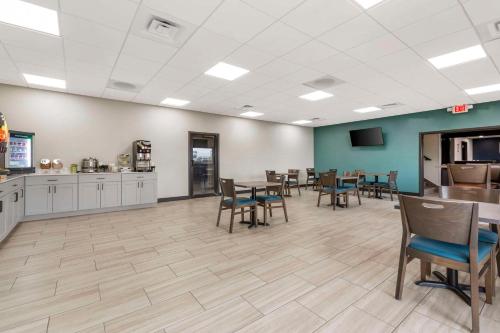 a waiting room with tables and chairs and a kitchen at Quality Inn Dillon I-15 in Dillon