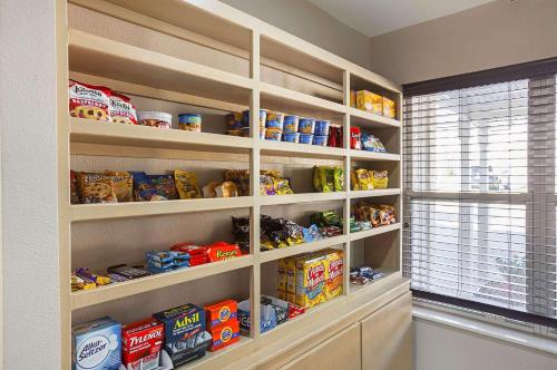a pantry with shelves filled with food and a window at Country Inn & Suites by Radisson, Lewisville, TX in Lewisville