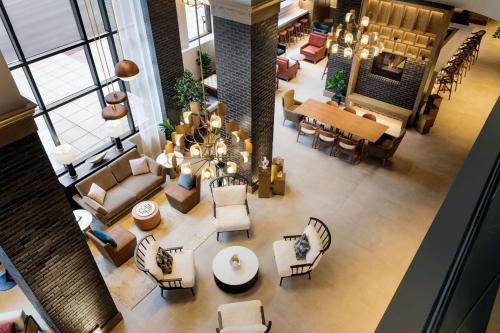 an overhead view of a living room and dining room at Tempo By Hilton Raleigh Downtown in Raleigh