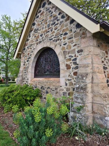 a stone building with a window on the side of it at Cherrywood-luxe retreat in the Southern Highlands in Exeter