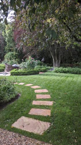 a stepping stone pathway in the grass in a garden at Cherrywood-luxe retreat in the Southern Highlands in Exeter