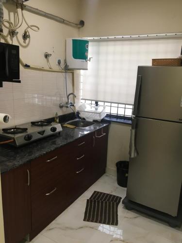 a kitchen with a refrigerator and a counter top at Family Friendly Guest House in Bengaluru