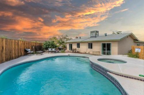 a swimming pool in the backyard of a house at Pool & Hot Tub! Centrally Located, Less Than 3 Miles to The Strip! in Las Vegas