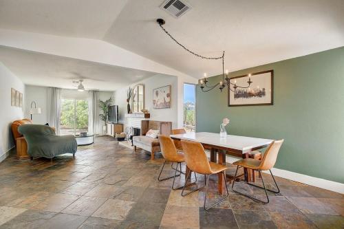 a dining room and living room with a table and chairs at Pool & Hot Tub! Centrally Located, Less Than 3 Miles to The Strip! in Las Vegas