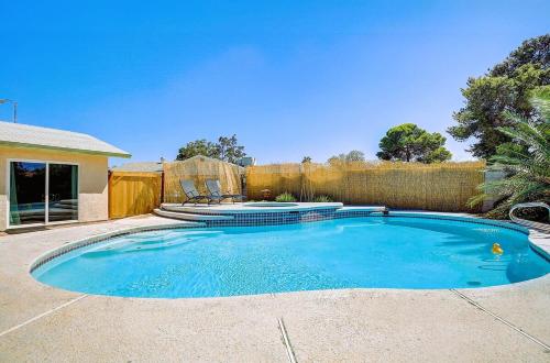 a swimming pool in a yard with a fence at Pool & Hot Tub! Centrally Located, Less Than 3 Miles to The Strip! in Las Vegas
