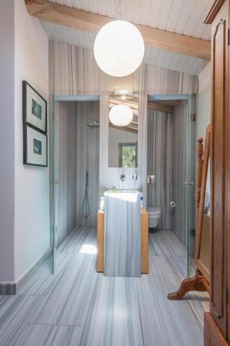 a room with a bathroom with a sink and a mirror at Limnos Experience in Mirina