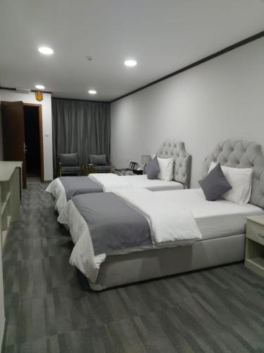 a large bedroom with two large beds in it at Daraysh Hotel in Sharjah