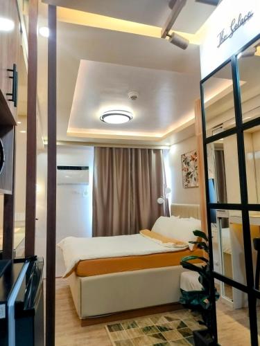 a small bedroom with a bed and a window at The Solace Place- Near Nuvali Sta Rosa Laguna in Bayabasan