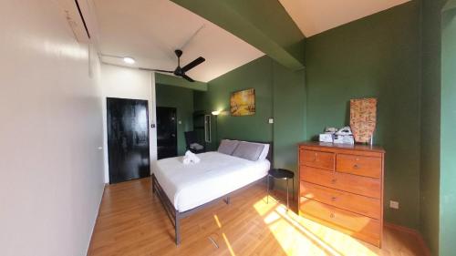a bedroom with a white bed and a dresser at 4-10 pax, Open concept BBQ at Private Seaview in Port Dickson