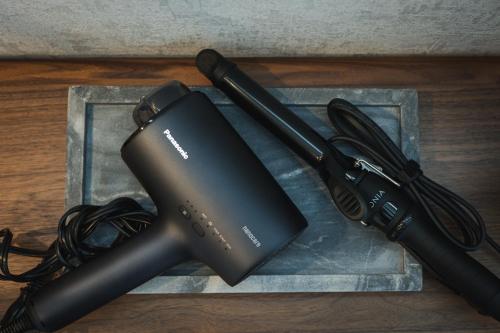 a gaming system on a table with a charger at THE HERO VILLA 米原ビーチリゾートishigaki in Ishigaki Island