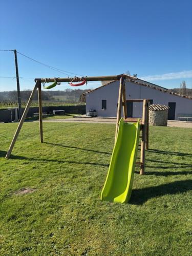 - une aire de jeux avec toboggan dans un champ dans l'établissement maison à la campagne, à Cleyrac