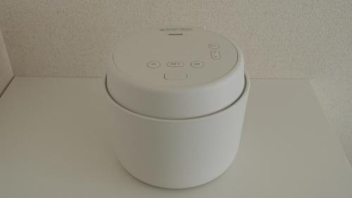 a white device sitting on top of a table at 5mins walk to Kameari Station within 30mins to Ginza, Asakusa, Skytree Direct bus to Haneda Airport & Tokyo Disneyland departing from Kameari Station in Tokyo