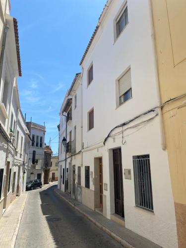 an empty street in an alley with white buildings at Casa Carmen Oliva Townhouse in Oliva