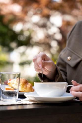 a person sitting at a table with a bowl of food at Aerinon Guesthouse in Nafplio