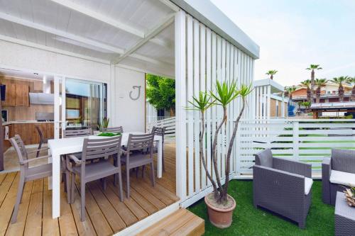 a patio with a table and chairs on a deck at Villaggio Camping Duca Amedeo in Martinsicuro