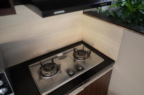a stove in a kitchen with two pots on it at Villa Jerami & Spa in Seminyak