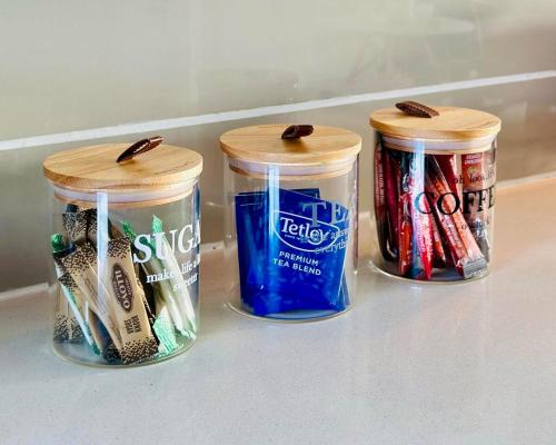 three jars of toothbrushes and toothpaste are sitting in a refrigerator at StayEase 3BR apartment with Pool Spa & Gym in Johannesburg