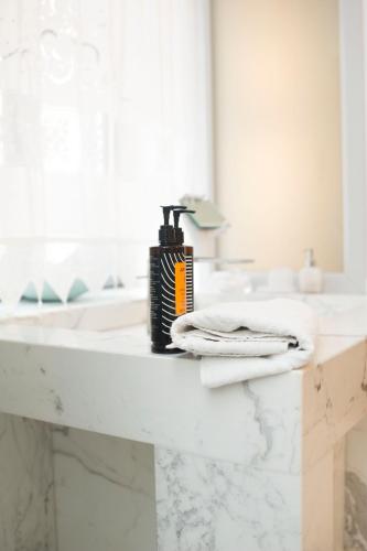 a bathroom counter with towels and a blow dryer on it at Limnos Experience in Mirina