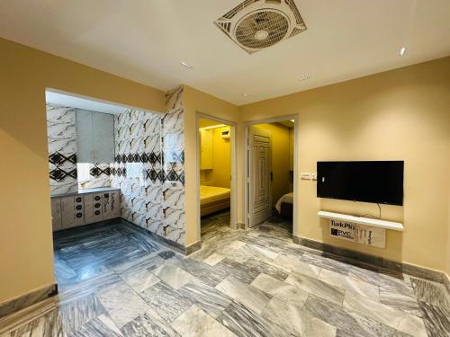 a large room with a television and a bathroom at Aleph Residence 1 Bed Room Apt Citi Housing Main Road Gujranwala in Ado Rāi