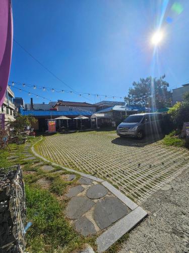 a car parked in a parking lot next to a train at Doggebi Stay in Gunsan