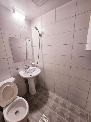 a bathroom with a toilet and a sink at Doggebi Stay in Gunsan