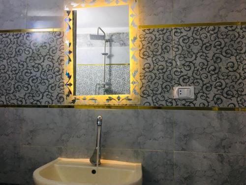 a bathroom with a sink and a mirror at Champollion apartments in Cairo