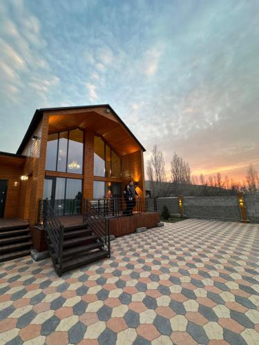 a small building with a person standing in front of it at Open House in Orto-Say