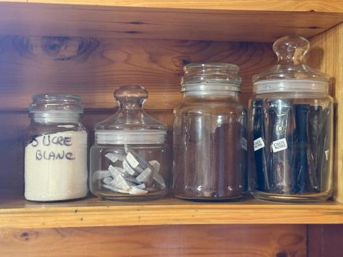 a shelf with several glass jars on it at Maroe Bay Lodge in HUH